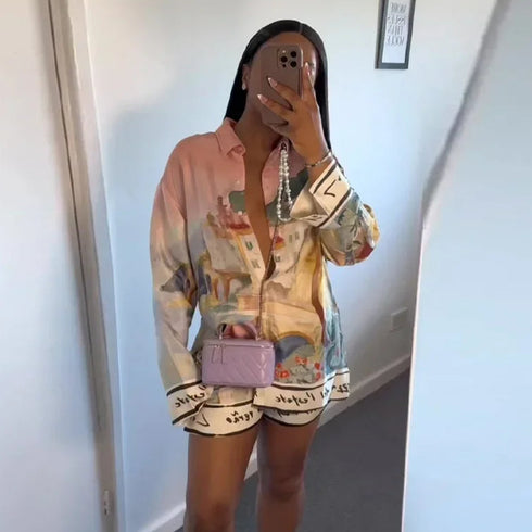Person wearing a colorful outfit with a matching bag in a mirror selfie.